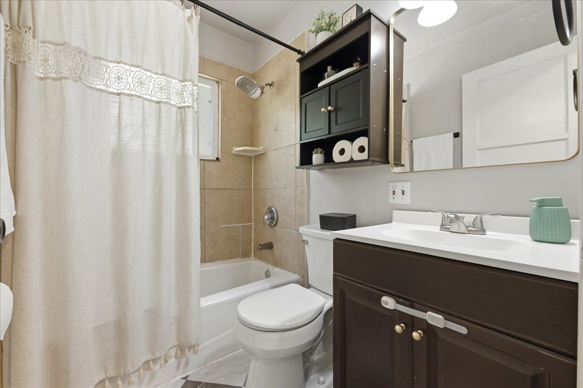Full bathroom featuring vanity and shower / bath combo