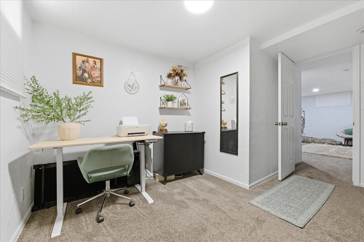 Office featuring light colored carpet and baseboards