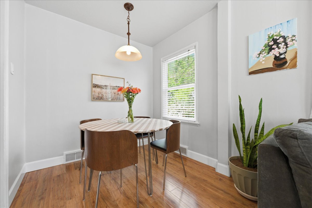 Dining space featuring hardwood / wood-style floors and lofted ceiling