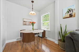 Dining space featuring hardwood / wood-style floors and lofted ceiling