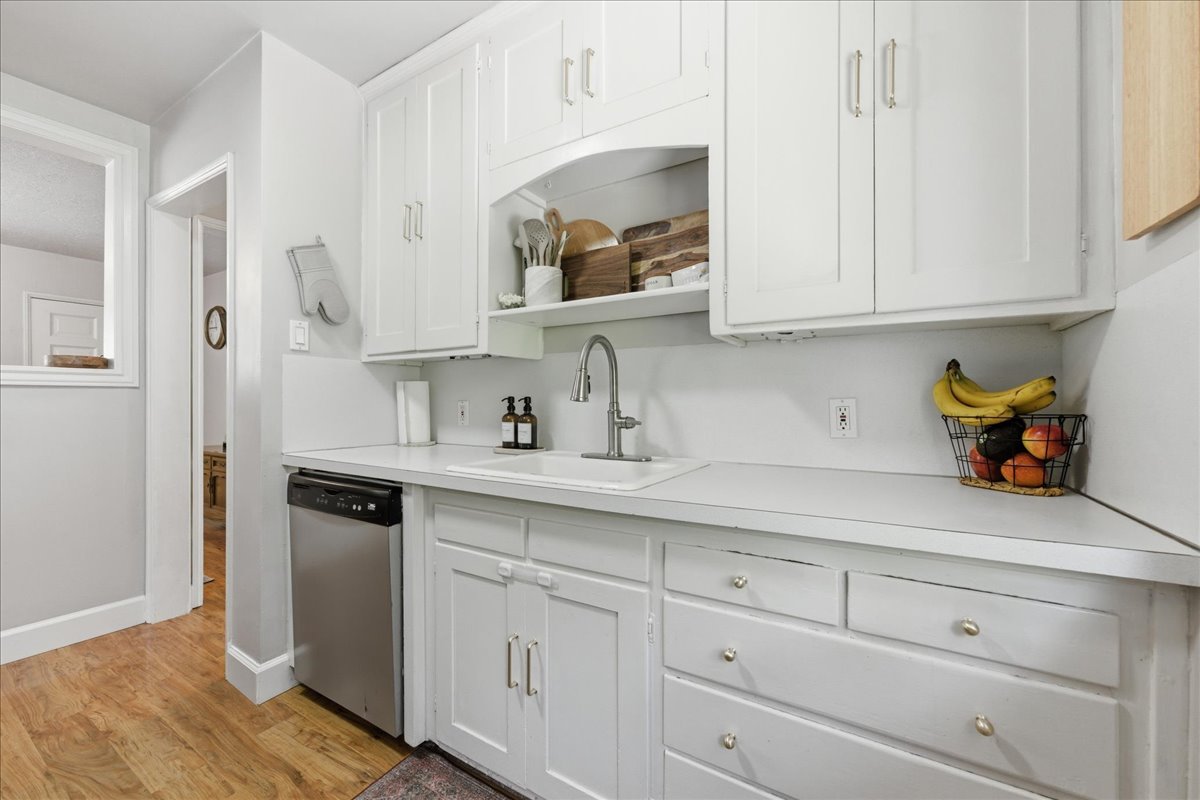 Kitchen with white cabinets and light countertops