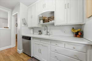 Kitchen with white cabinets and light countertops