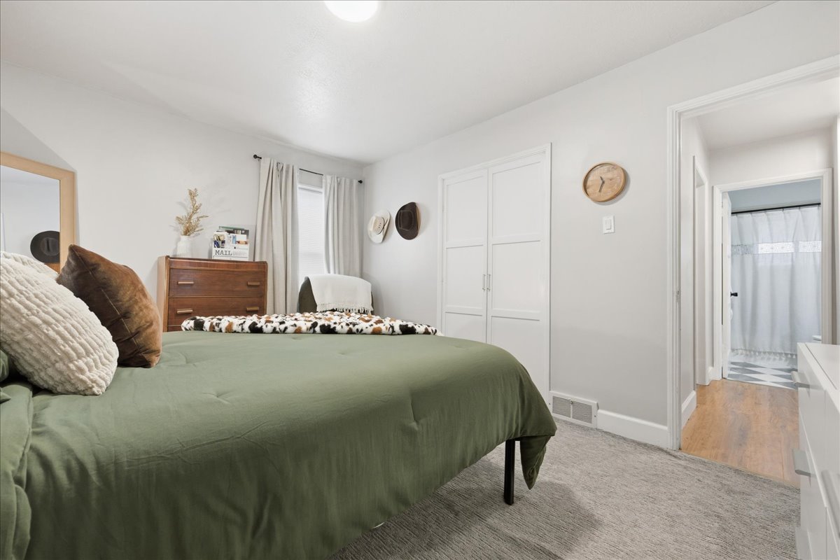 Bedroom with light carpet and baseboards