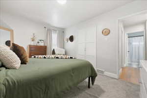 Bedroom with light carpet and baseboards