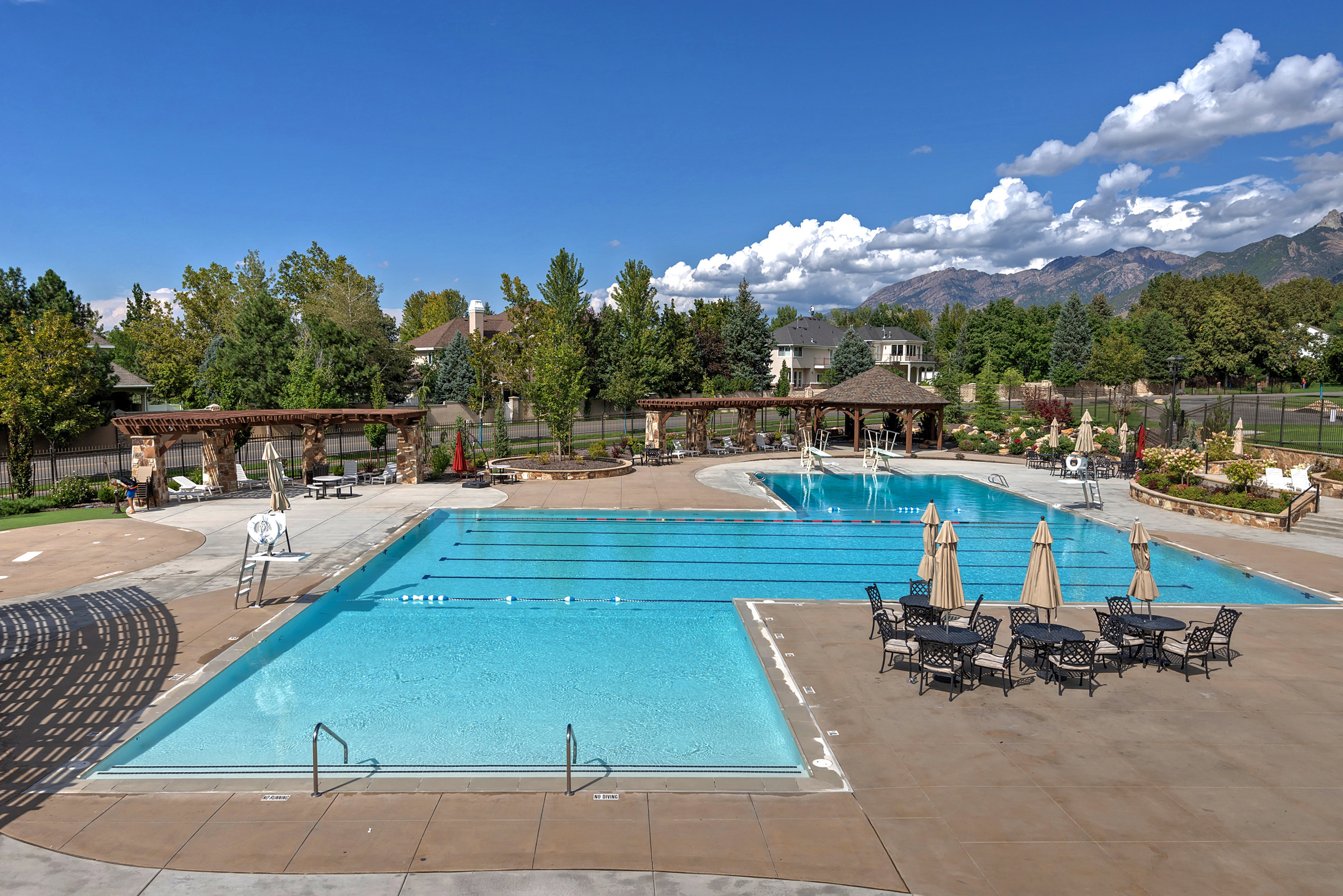 Community pool with a pergola, a patio, and a mountain view