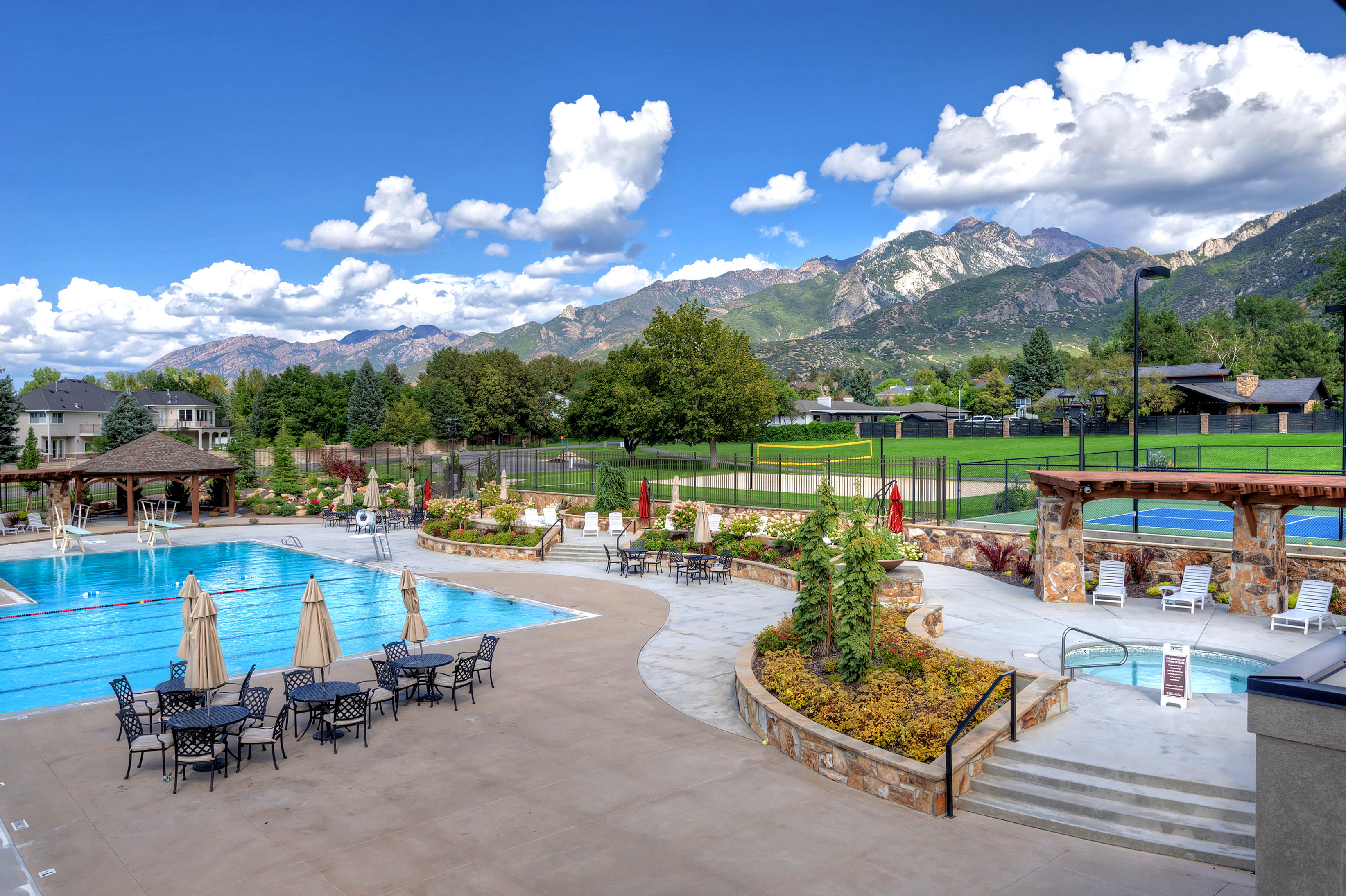 Community pool featuring a patio area, a mountain view, a gazebo, and a residential view