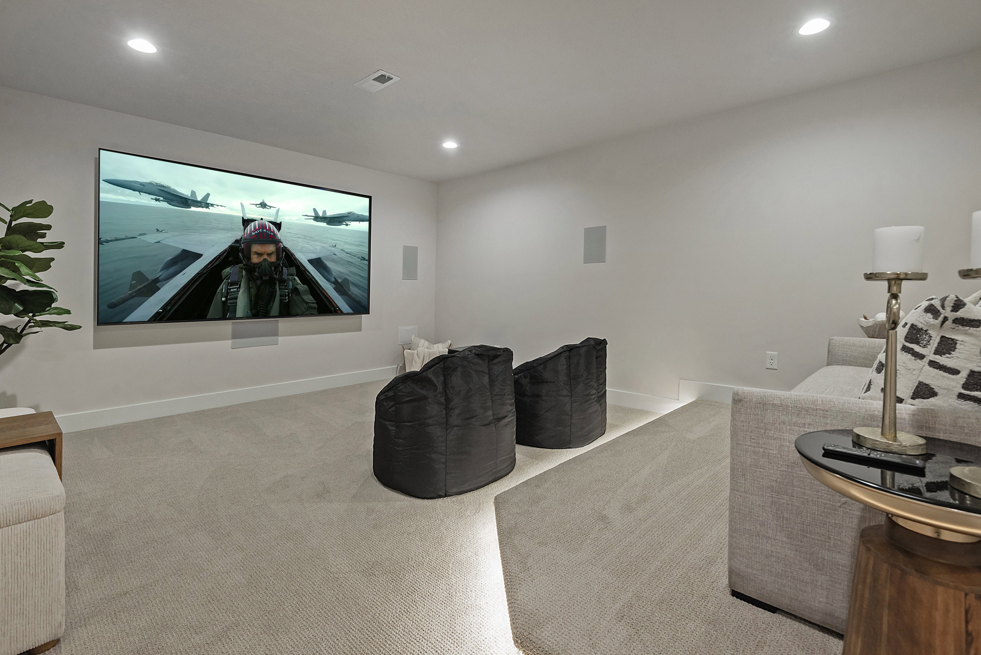 Home theater with light carpet and recessed lighting