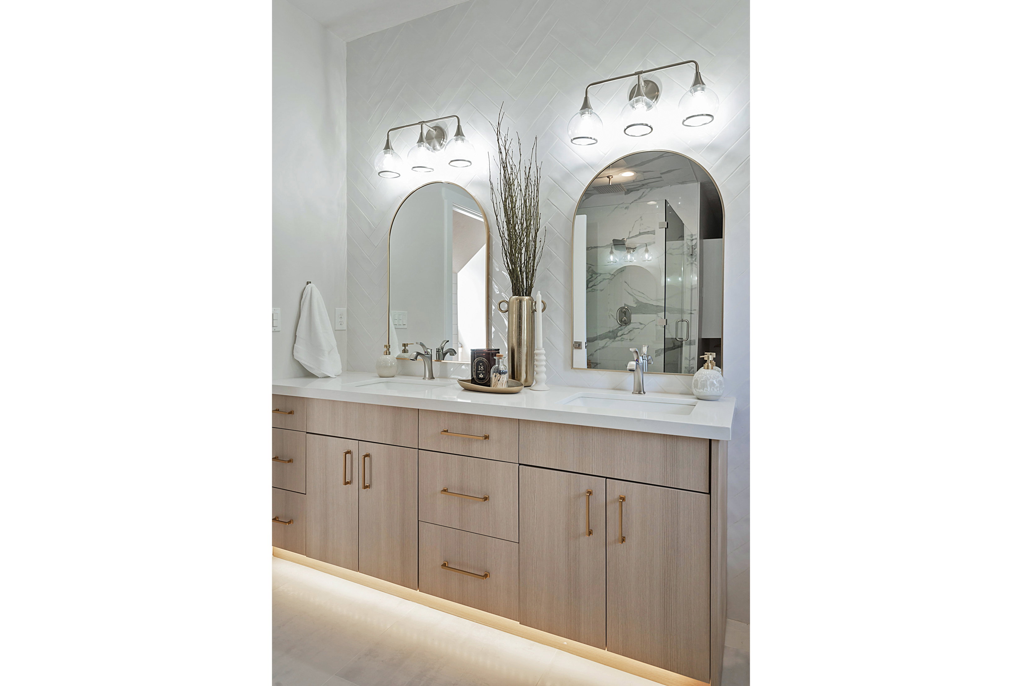 Bathroom with double vanity and a marble finish shower