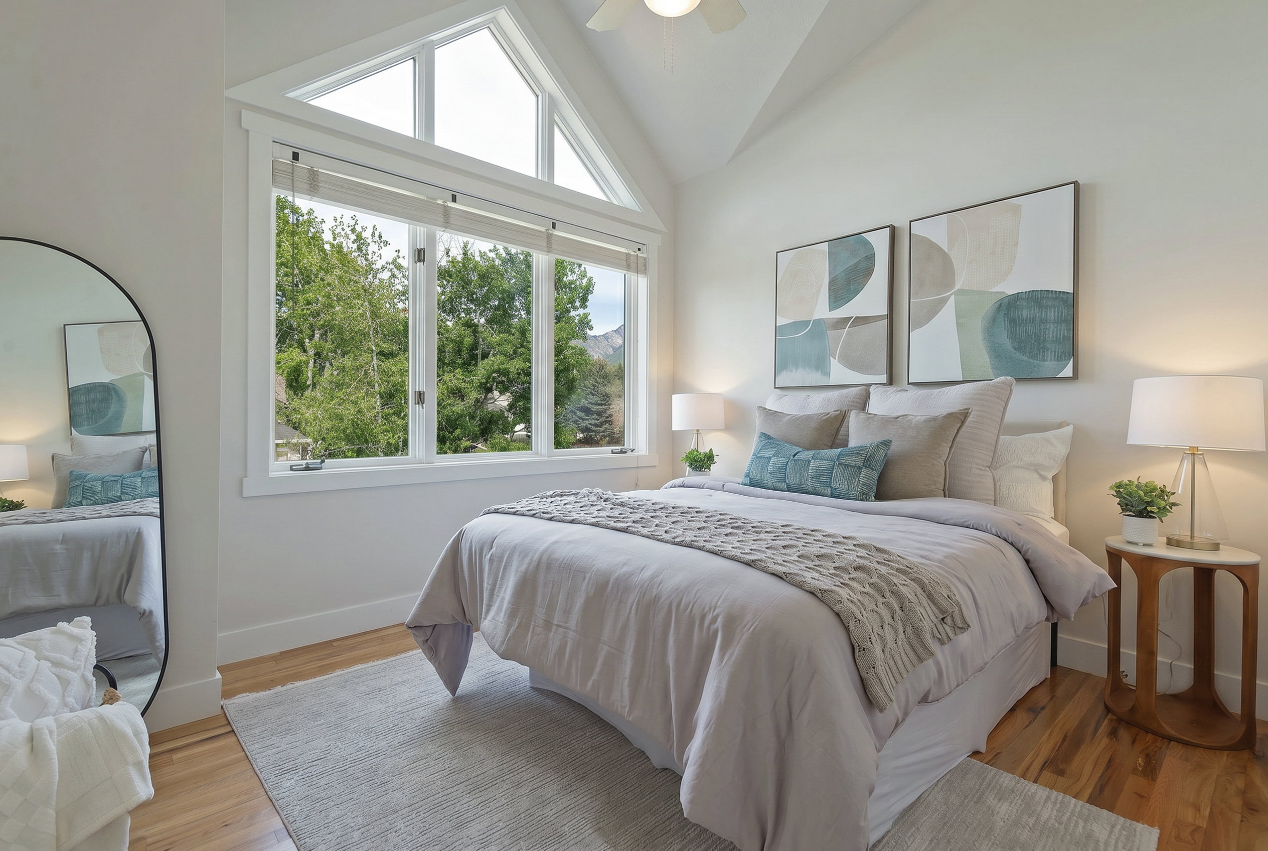 Bedroom featuring lofted ceiling, light wood-style floors, and ceiling fan, large windows
