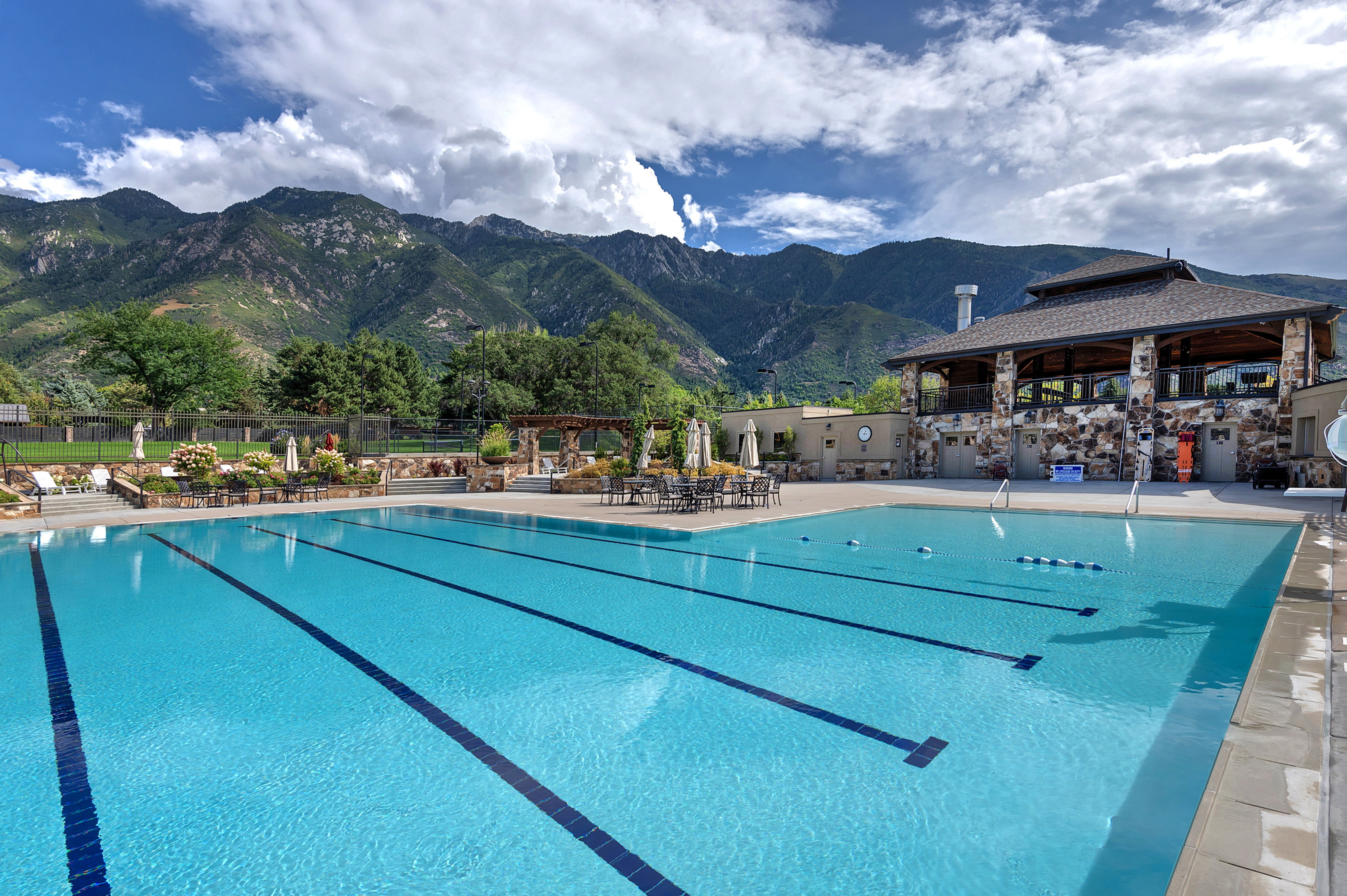 Community pool featuring a patio area, a mountain view, and a gazebo