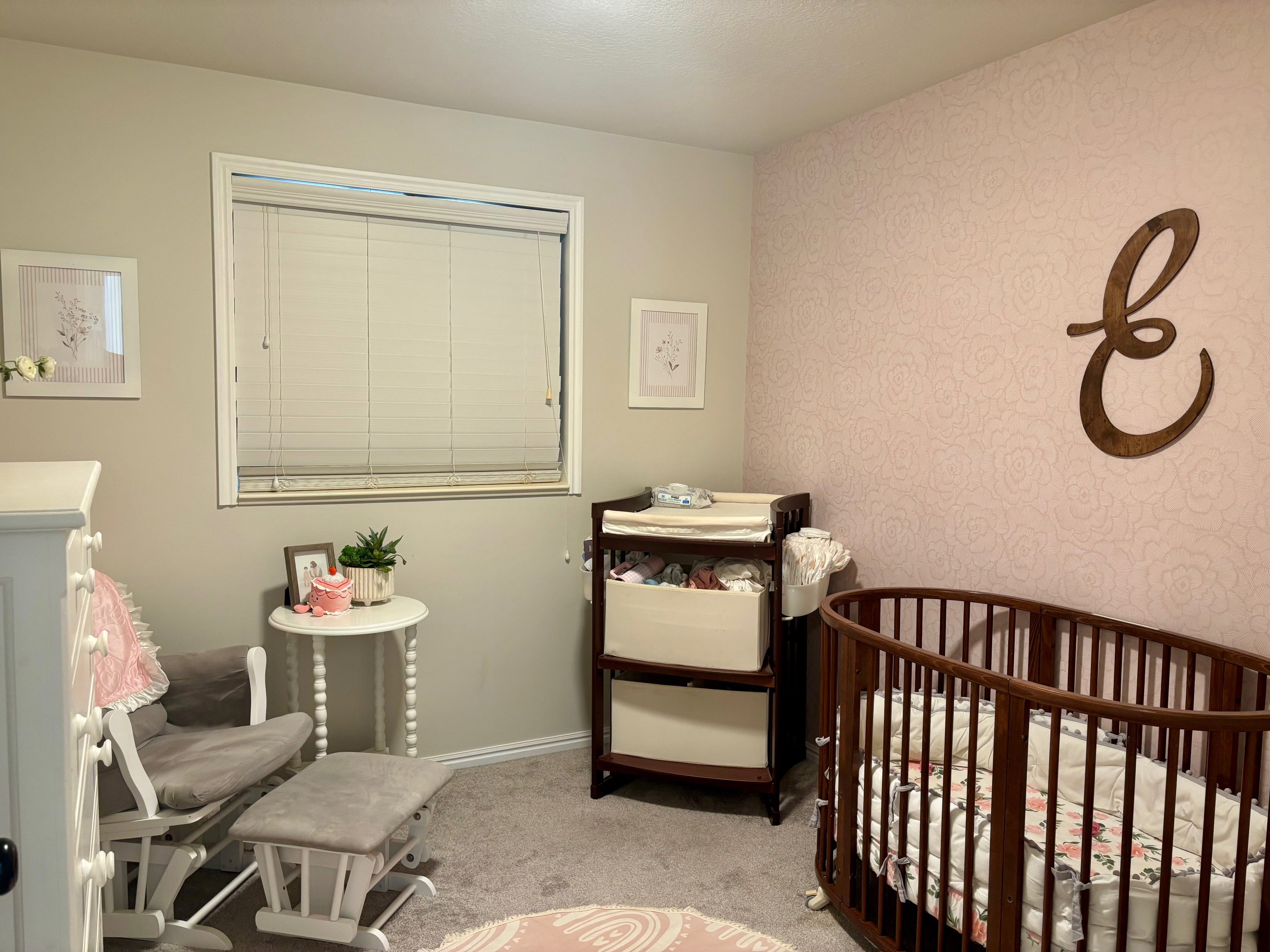 Room featuring light gray walls and an accent wall with subtle floral wallpaper