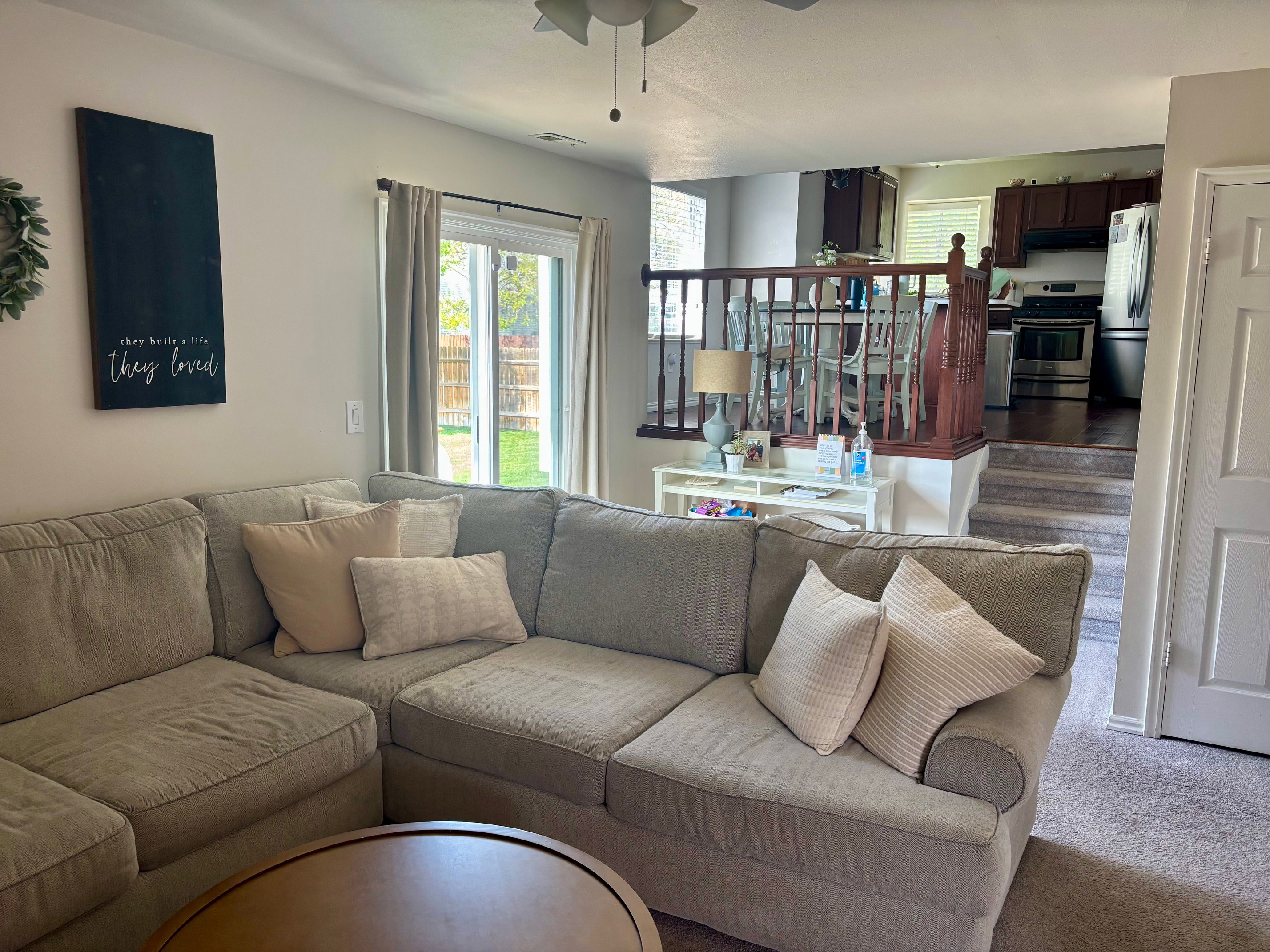 Living area featuring carpet flooring and a ceiling fan