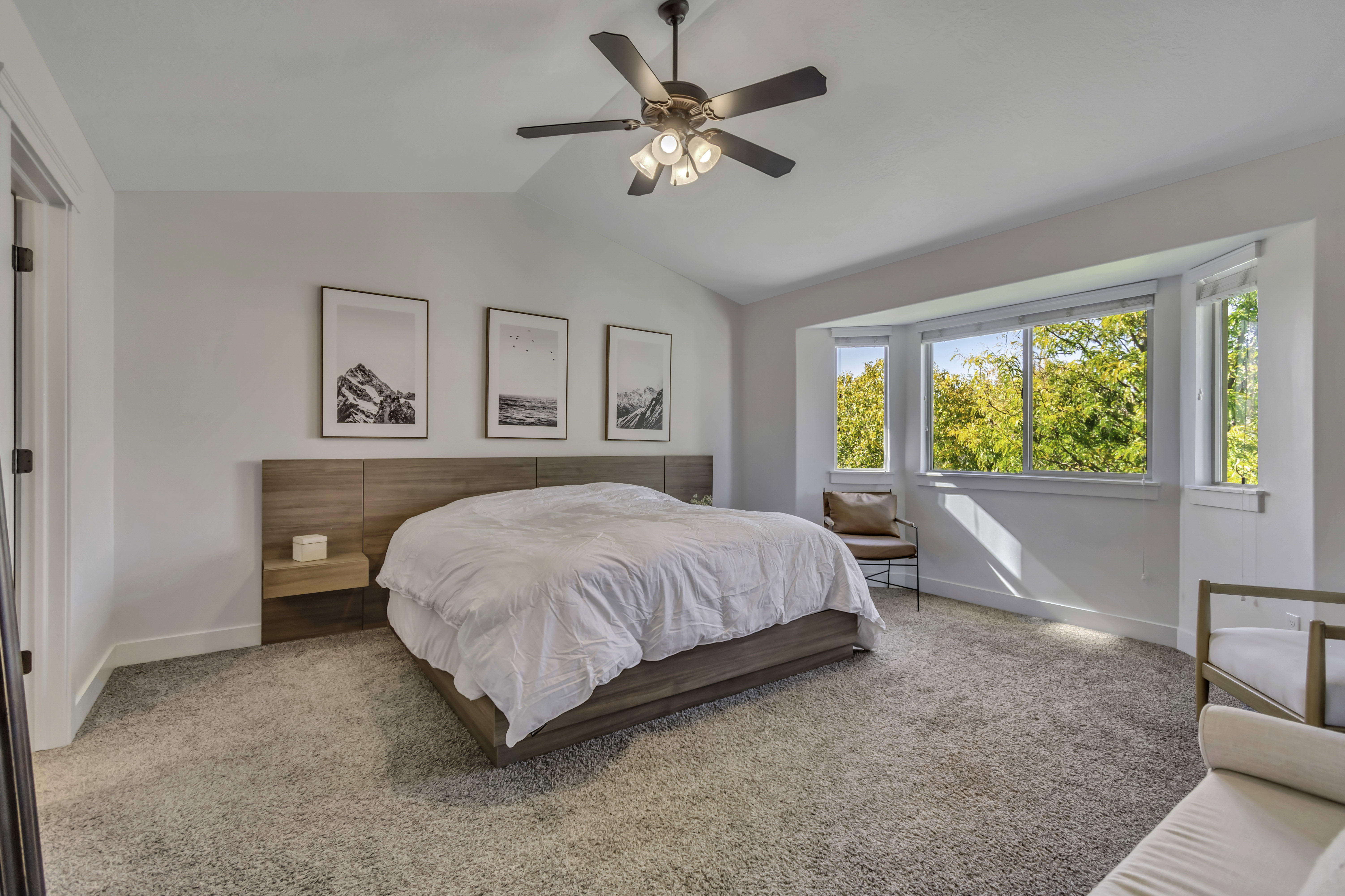 Carpeted bedroom with lofted ceiling and ceiling fan