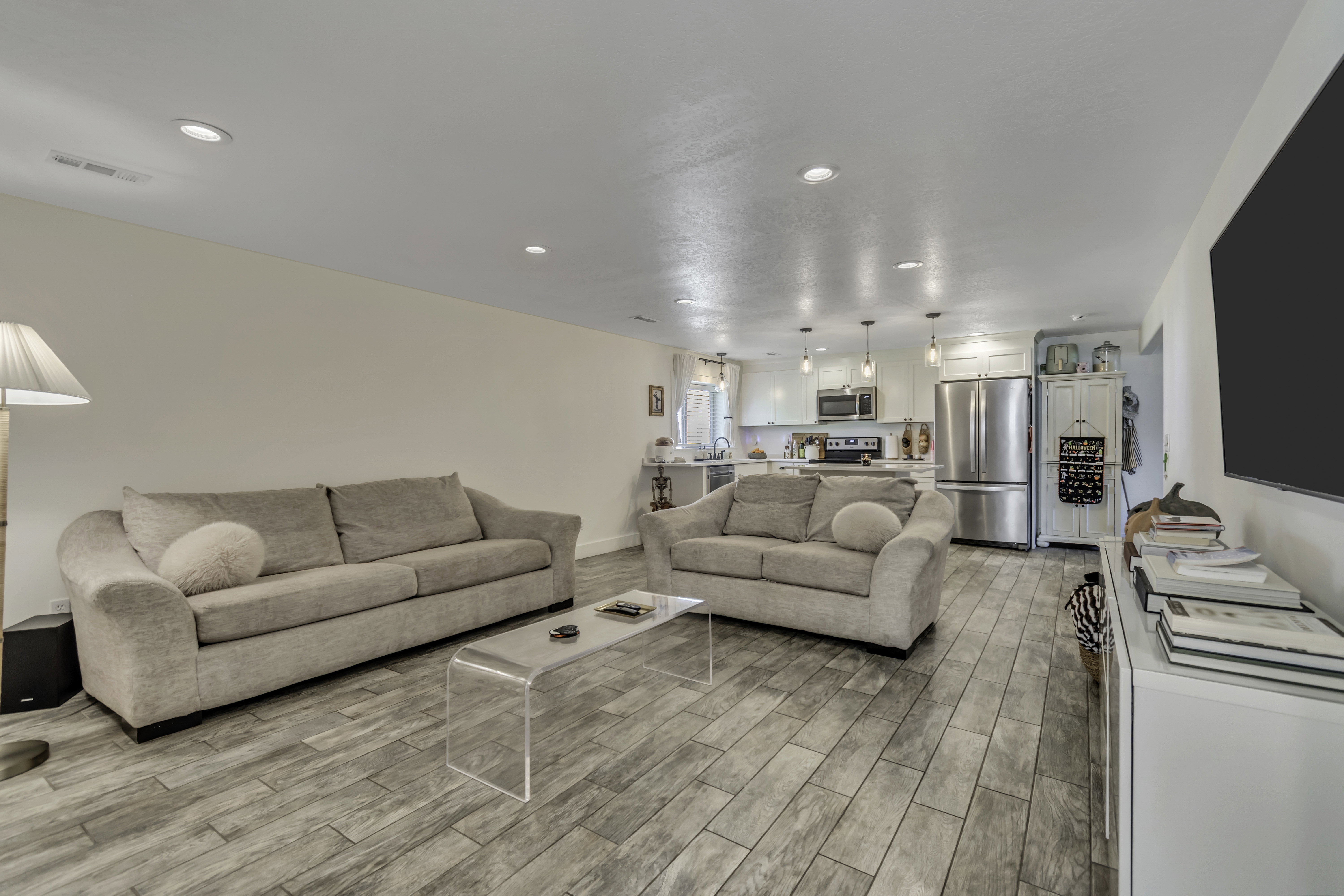 Living area with wood tiled floors and recessed lighting