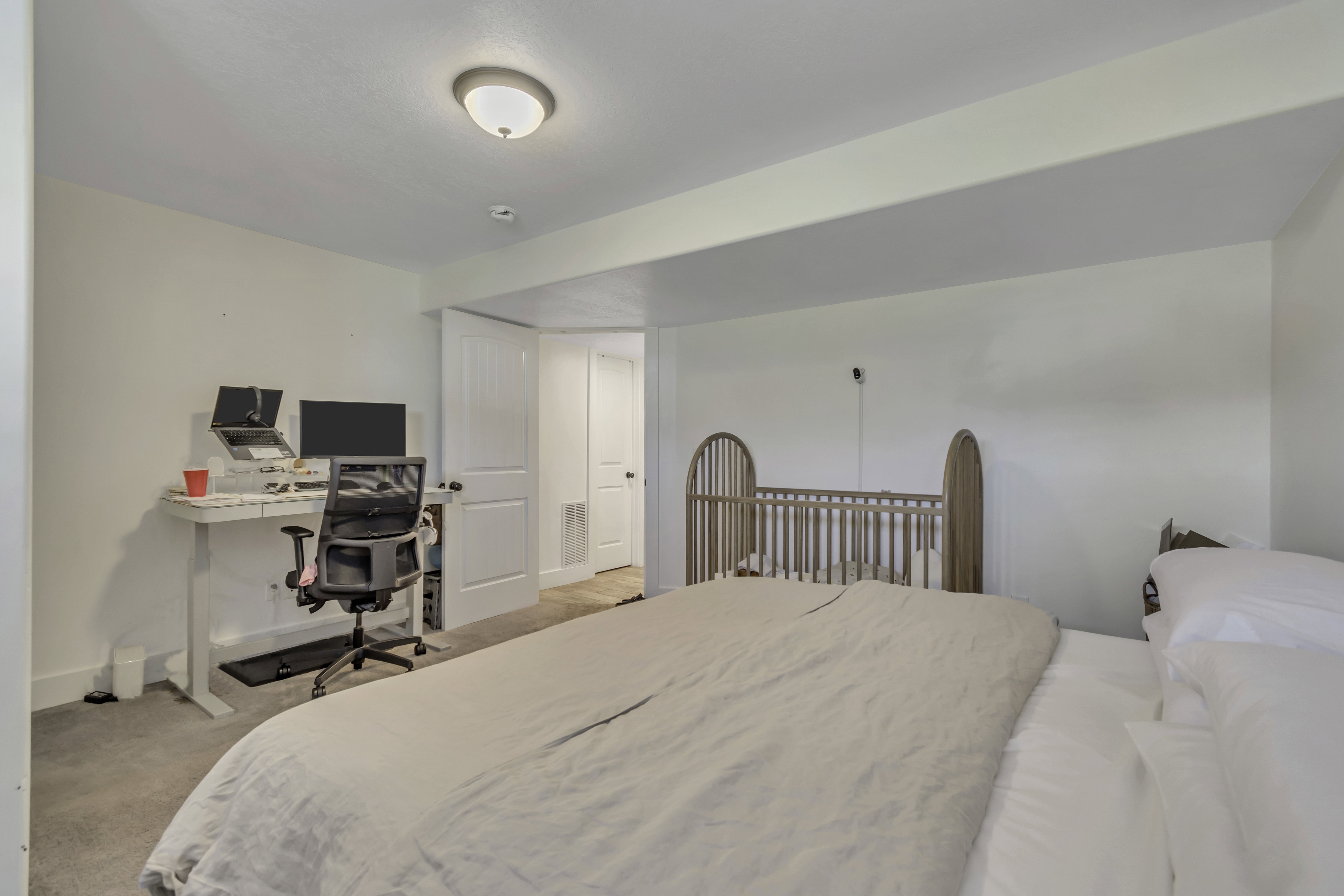 Bedroom featuring a desk and light carpet