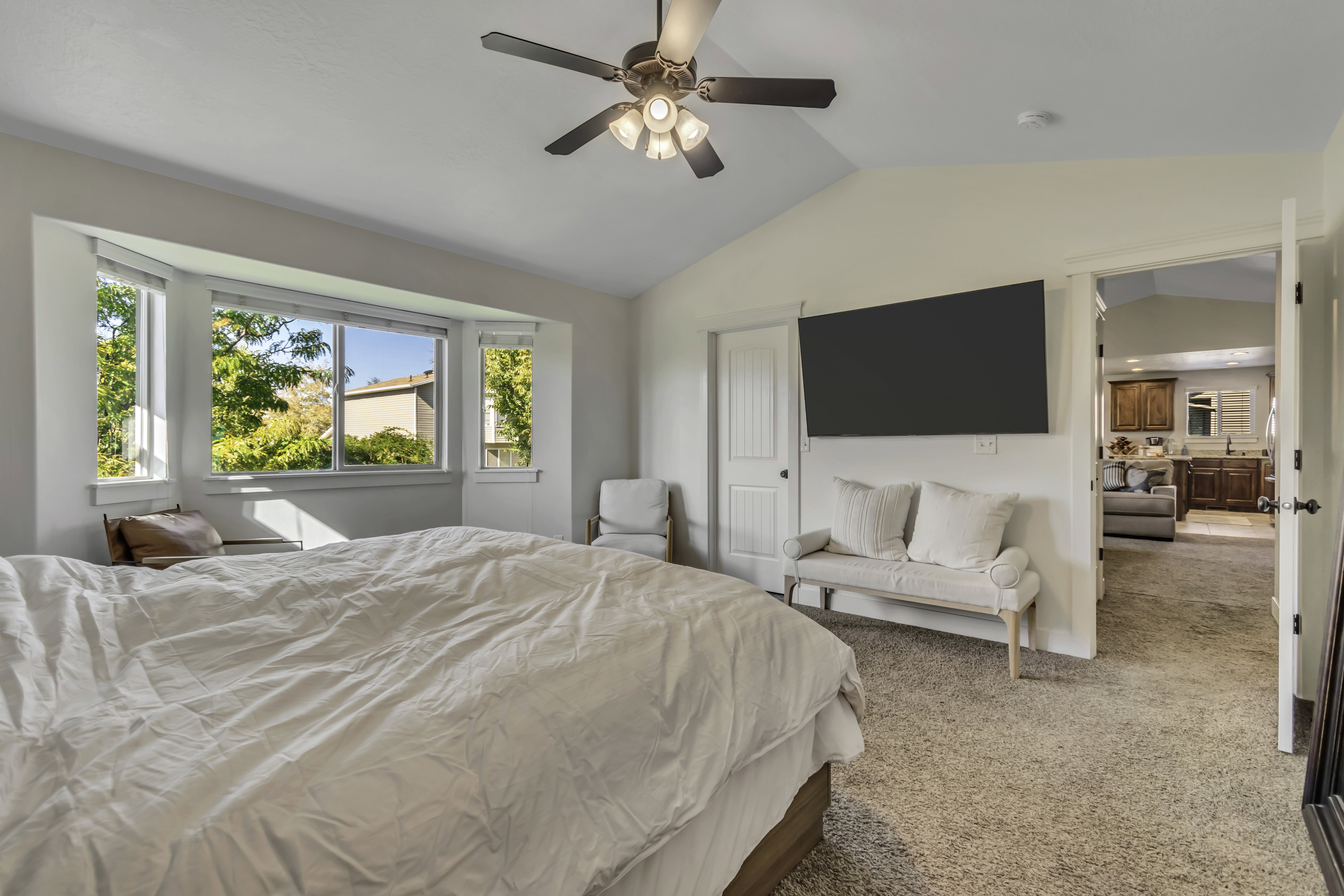 Carpeted bedroom featuring ceiling fan