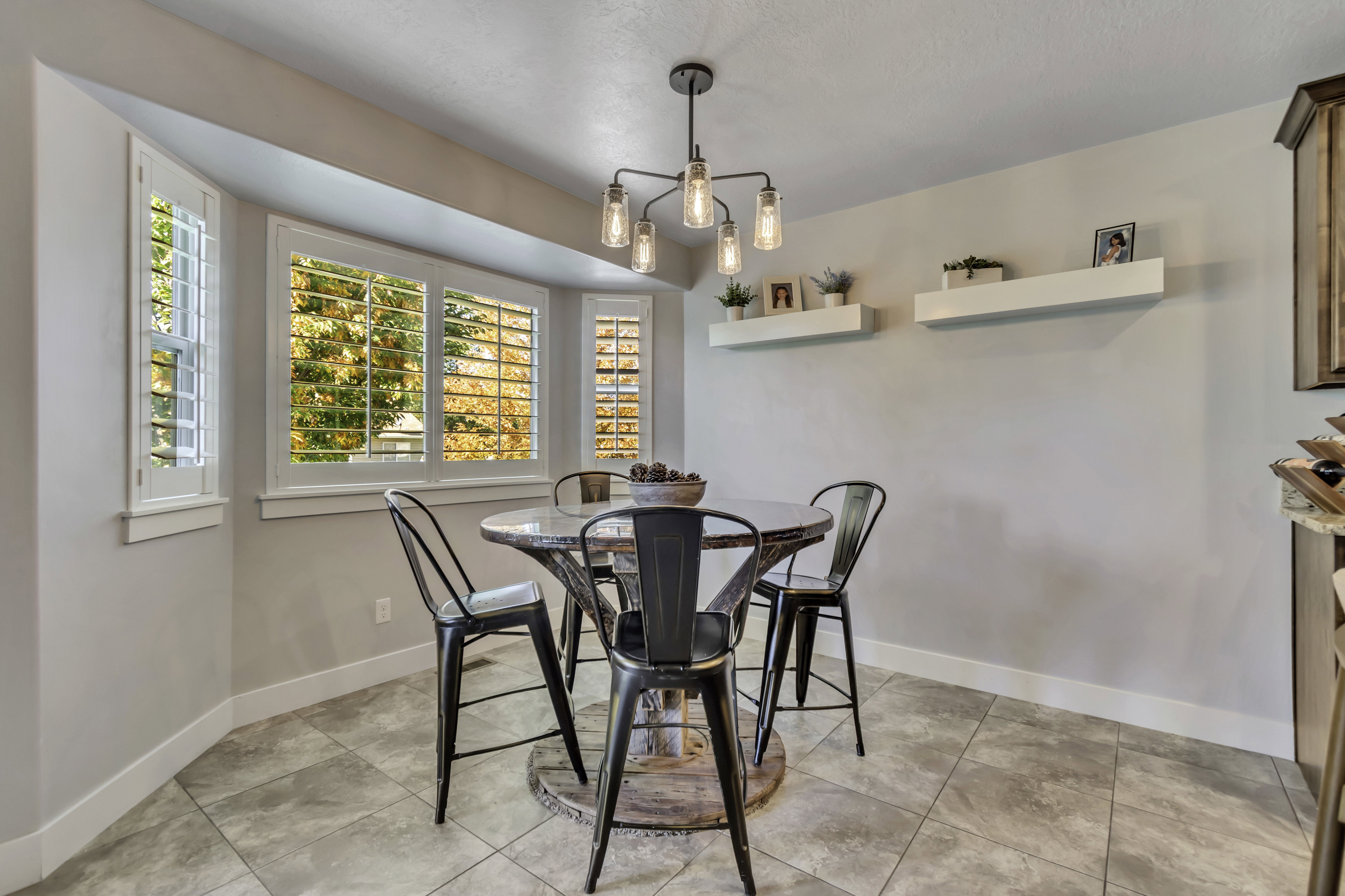 Dining area with hanging lights and light tile patterned flooring