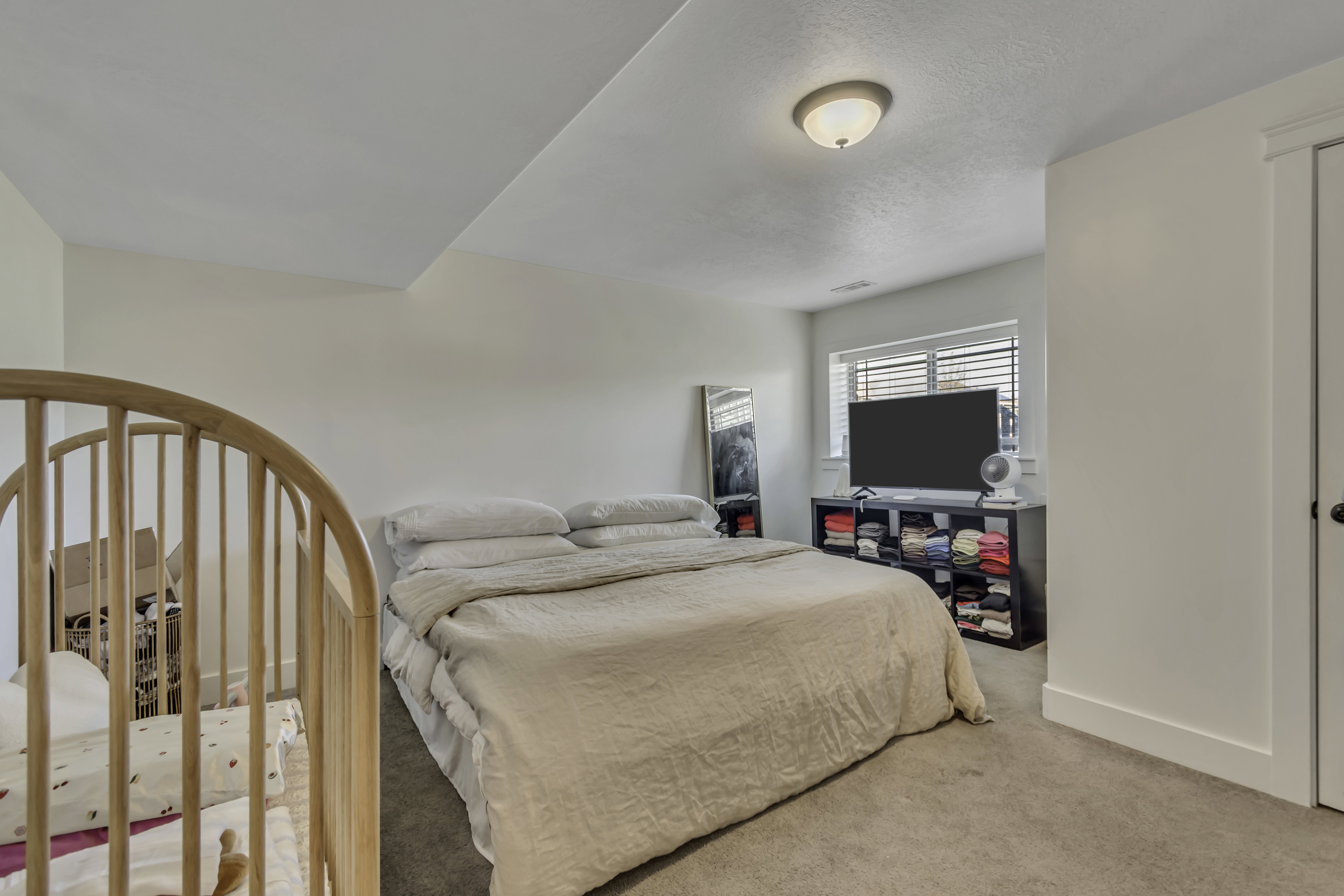 Bedroom featuring carpet and baseboards