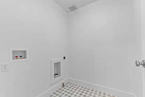 Utility room featuring white walls, a white ceiling, recessed lighting, and a plaid-patterned floor