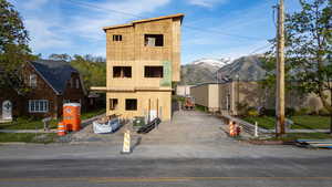 Newly framed multi-story structure with a contemporary roofline