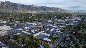 Expansive aerial perspective showcasing a vibrant urban landscape with prominent mountain backdrop