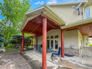 Covered patio featuring a wood-finish ceiling and substantial support columns