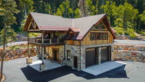 Mountain-style residence featuring a stone and wood siding exterior