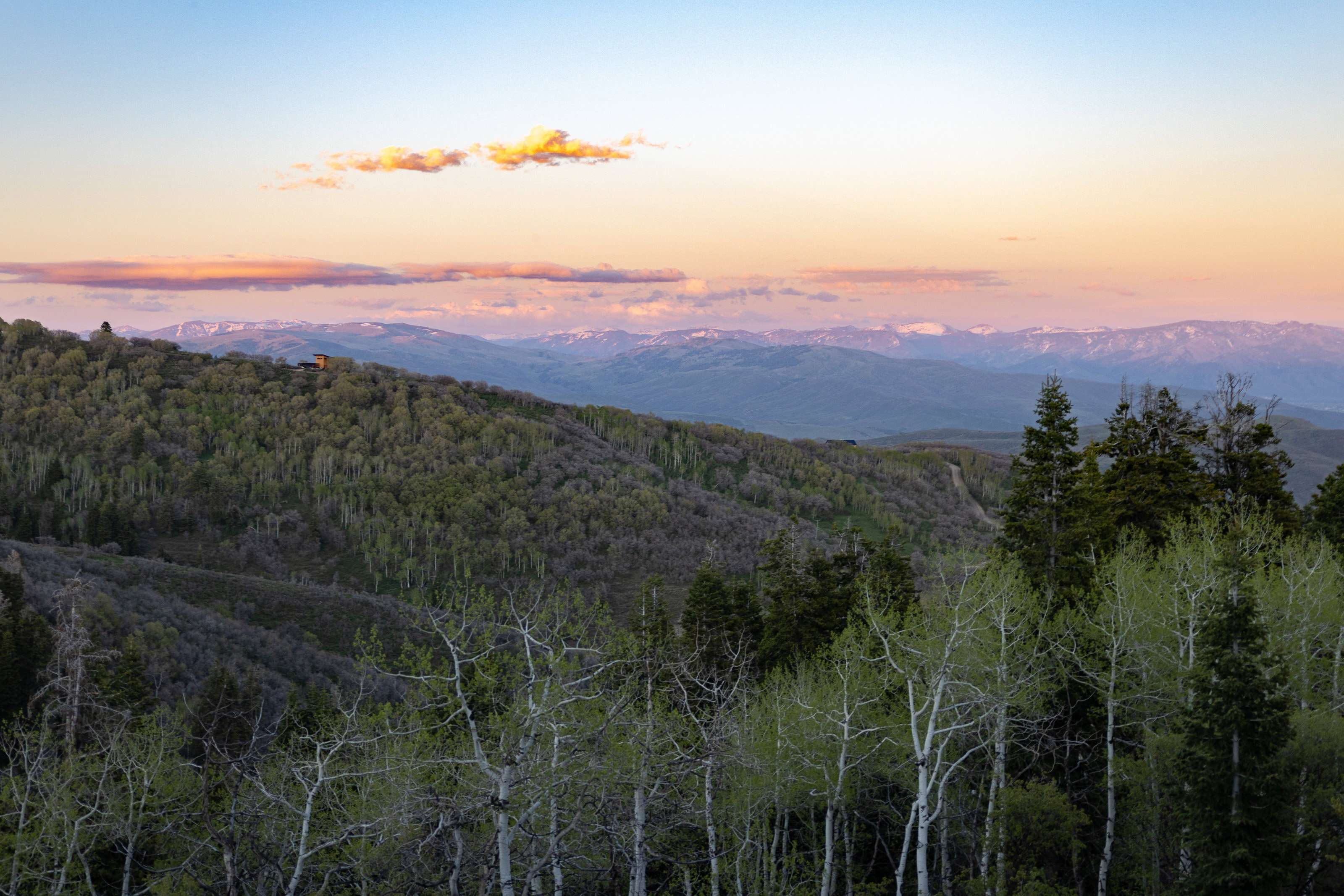 Expansive mountain range backdrop featuring snow-capped peaks