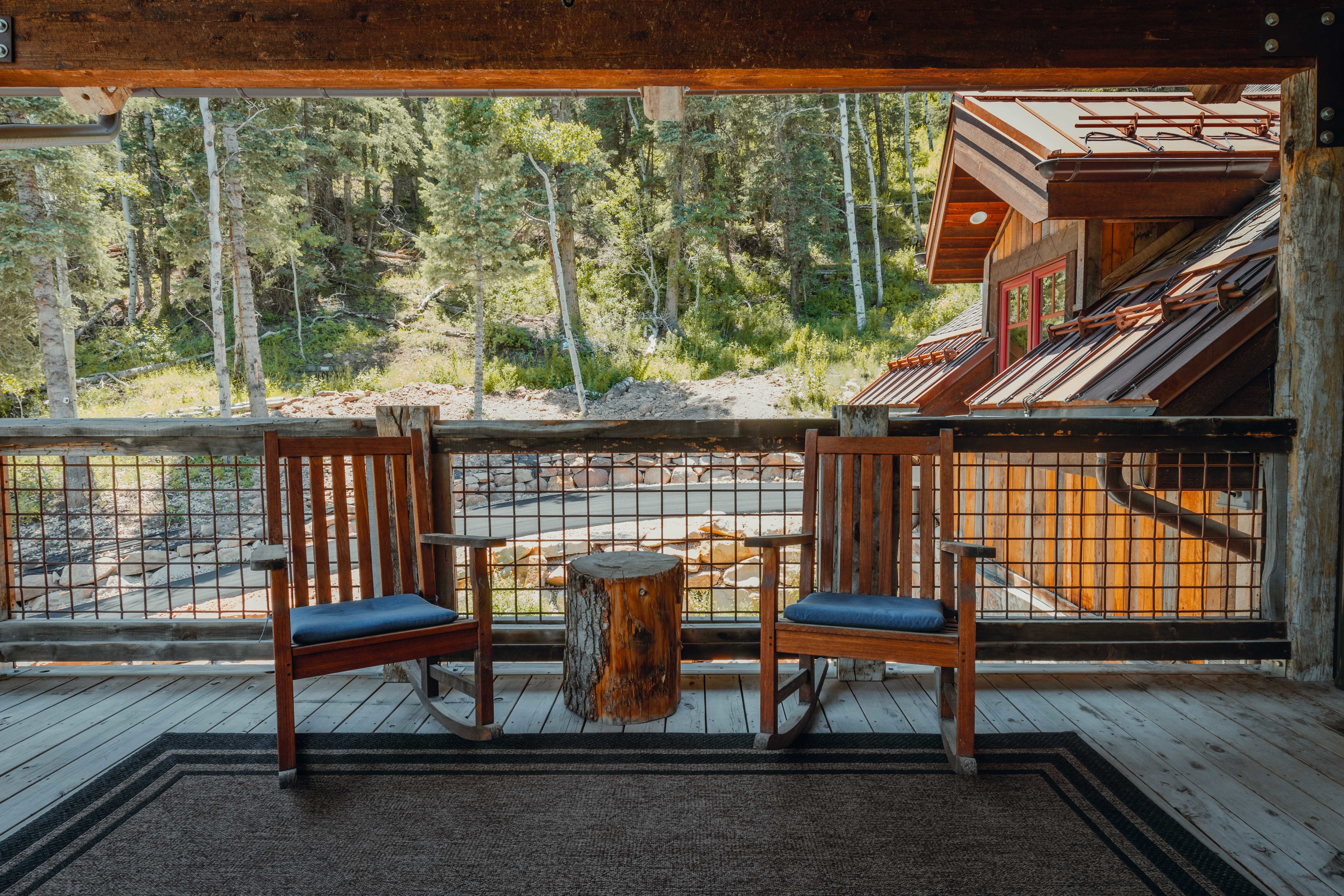 Spacious wood deck featuring rustic wood railing with grid infill