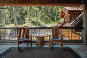 Spacious wood deck featuring rustic wood railing with grid infill