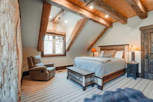 Vaulted wood-paneled ceiling with exposed wood beams and recessed lighting