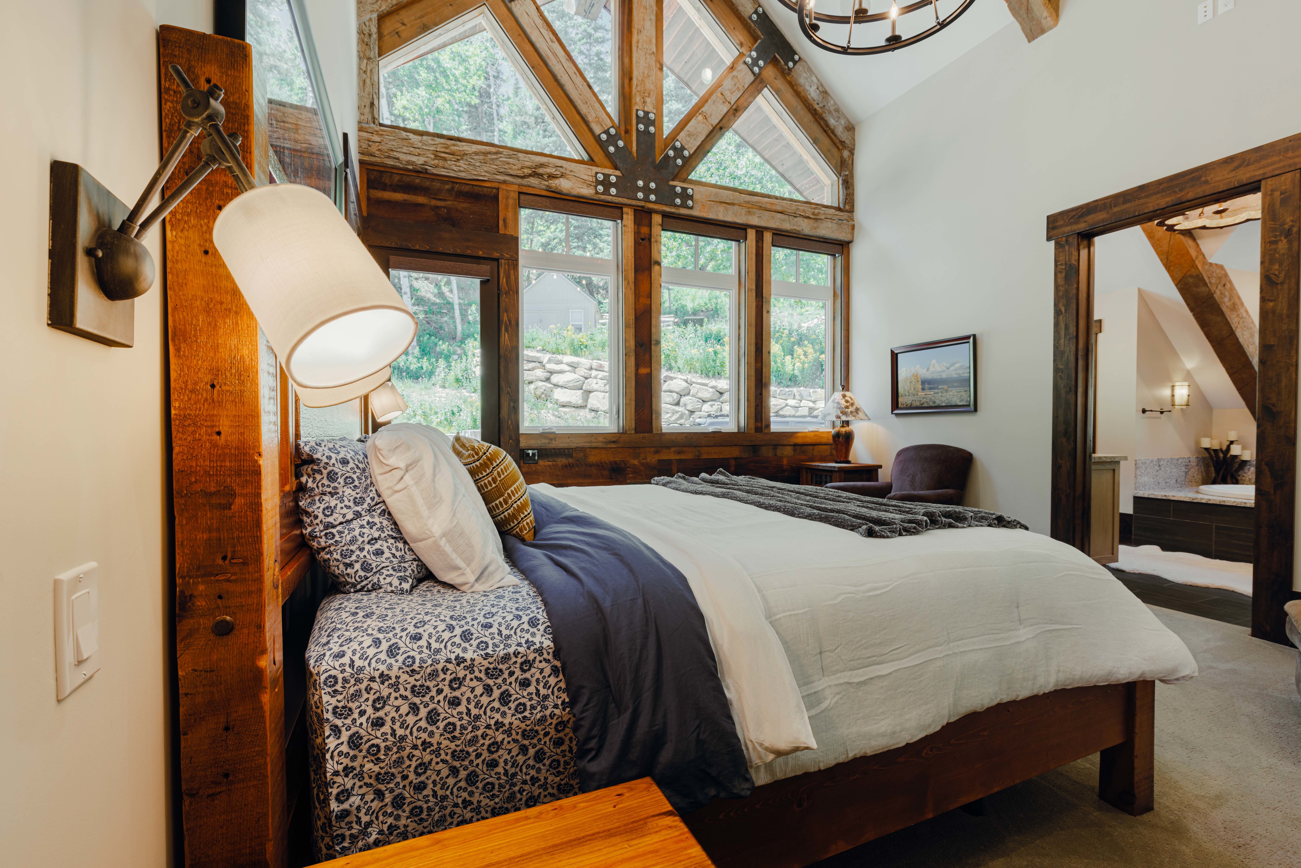 Vaulted ceiling with exposed wood beams and chandelier