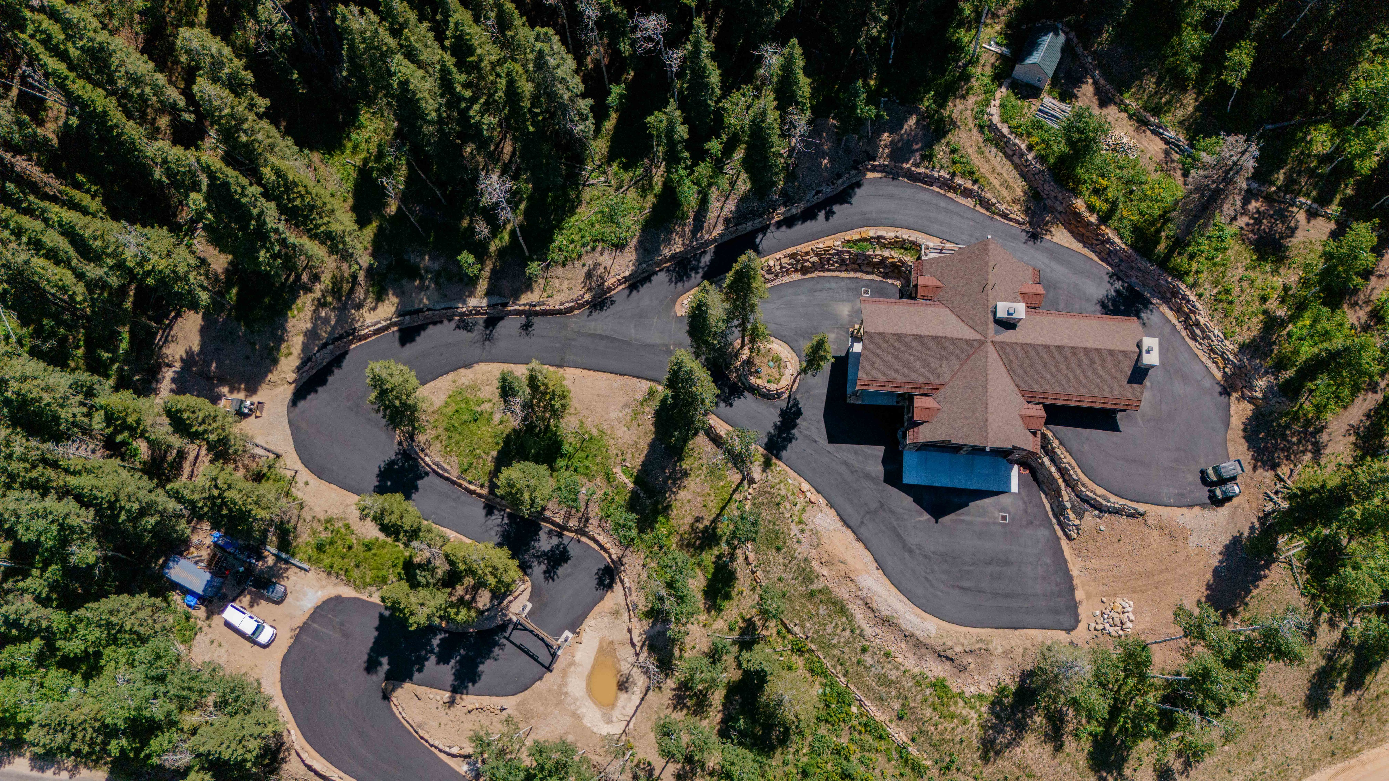 New construction residence featuring a multi-gabled roofline and extensive surrounding woodlands