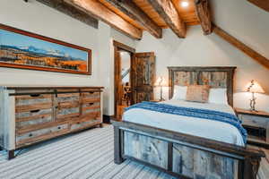 Rustic wood-finish architectural beams accentuating the vaulted ceiling