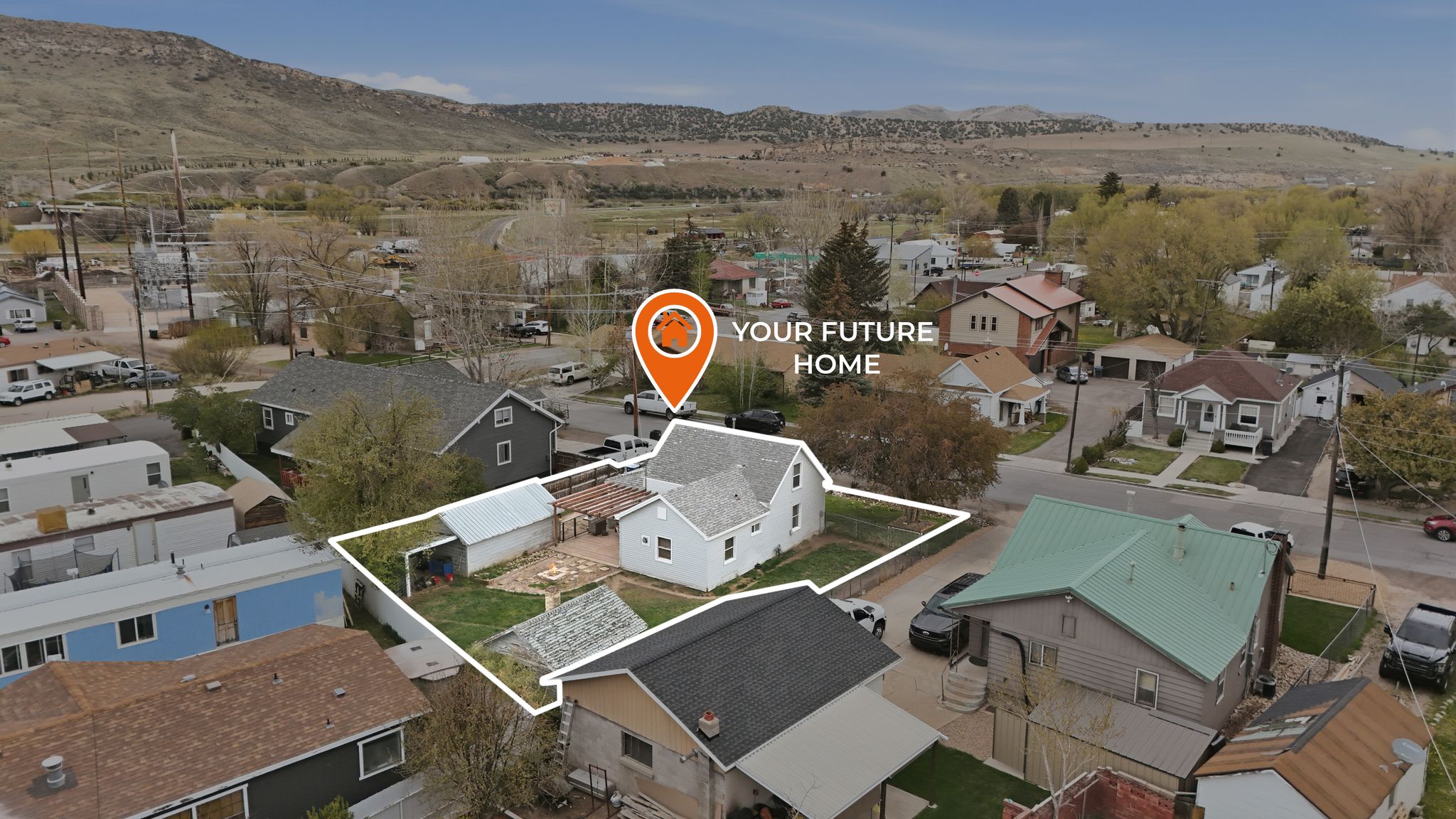 Cottage home featuring a fenced yard, a detached storage shed, and a paved patio area