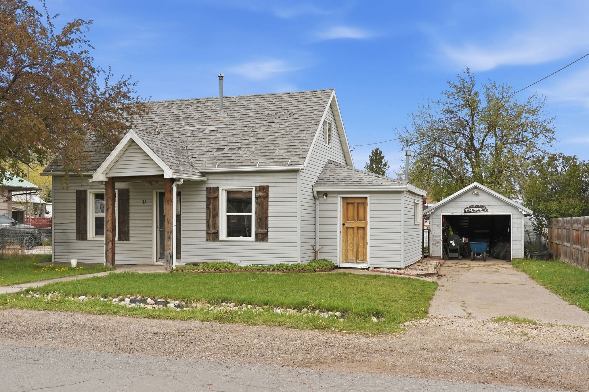Traditional single-story residence with light gray siding and a pitched roof