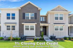Modern townhome exterior featuring a striking combination of white shake siding, light-colored board and batten siding, and dark brick