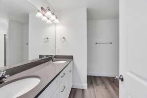 Dual vanity with undermount sinks, a continuous mirror, and a contemporary light fixture