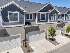 Contemporary townhome exterior featuring gray horizontal siding and stucco accents