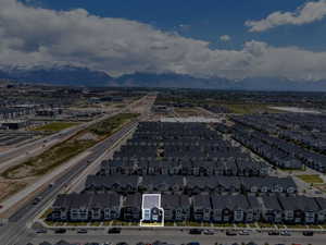 Aerial depiction of a neighborhood with a prominent mountain range backdrop
