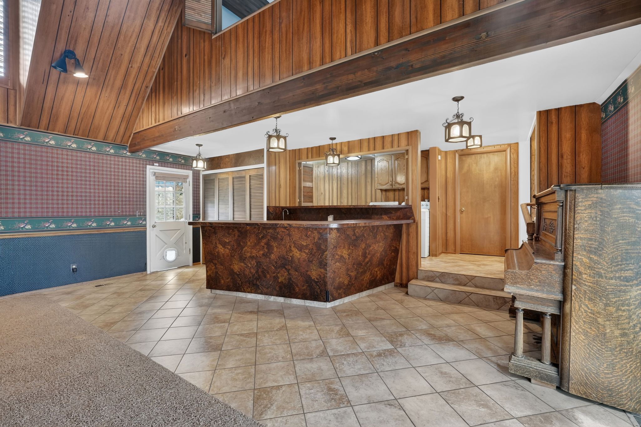 Vaulted wood-paneled ceiling with exposed beams