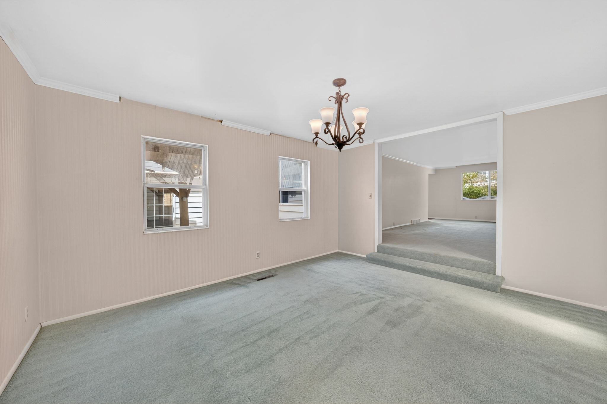Interior space featuring light beige textured wall coverings and a complementary light blue carpet