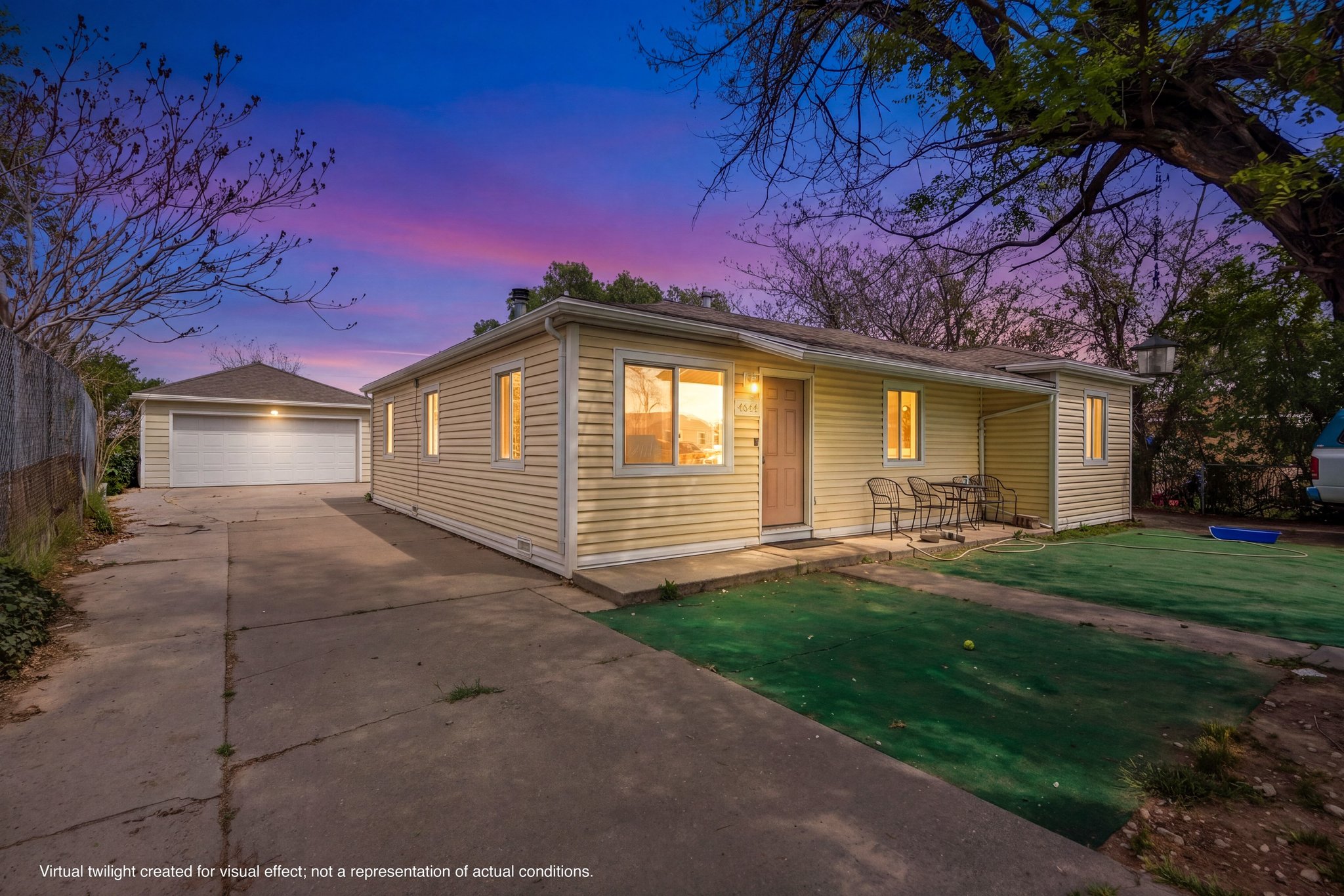 Ranch-style residence featuring horizontal siding, a covered patio, and an extended driveway
