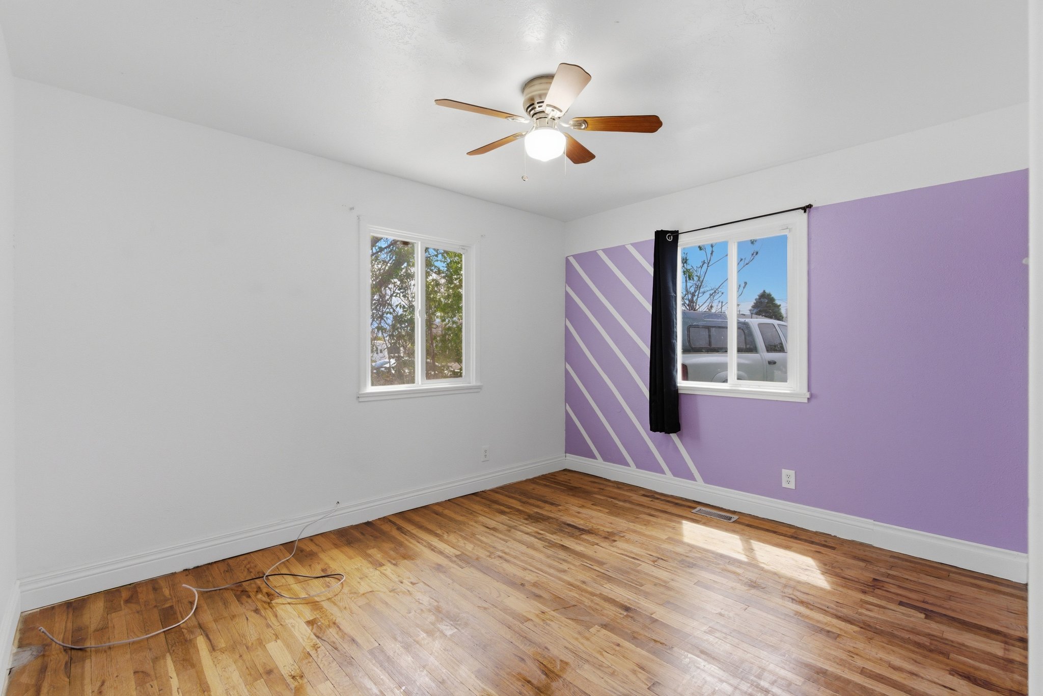 Room featuring wood-finish flooring and white baseboards
