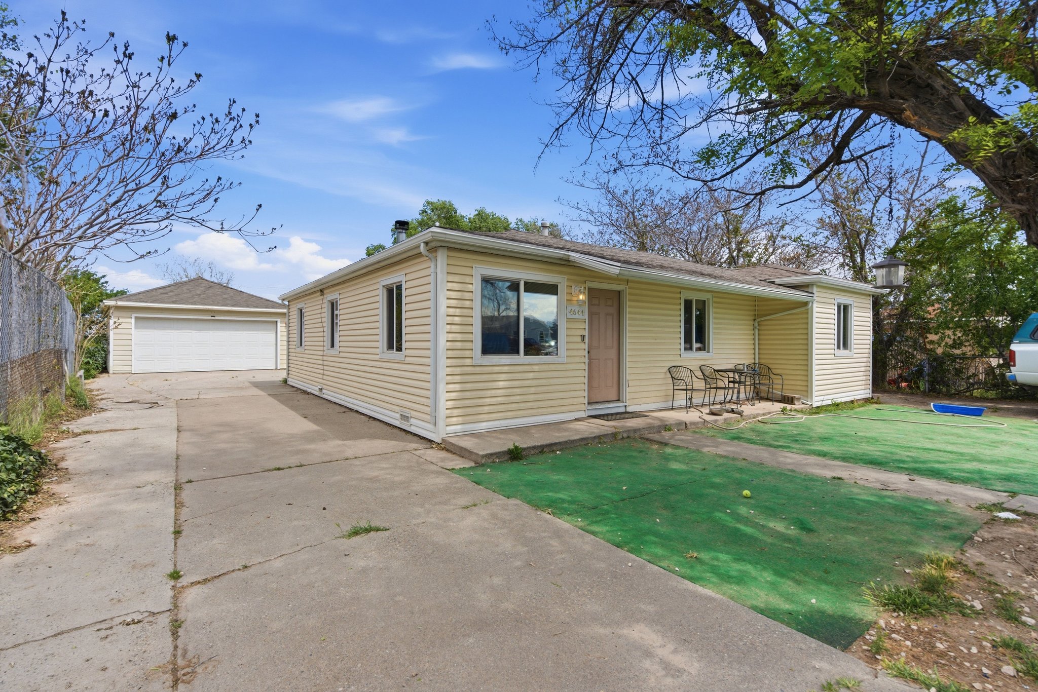 Exterior featuring horizontal siding, a covered patio area, and a detached two-car garage