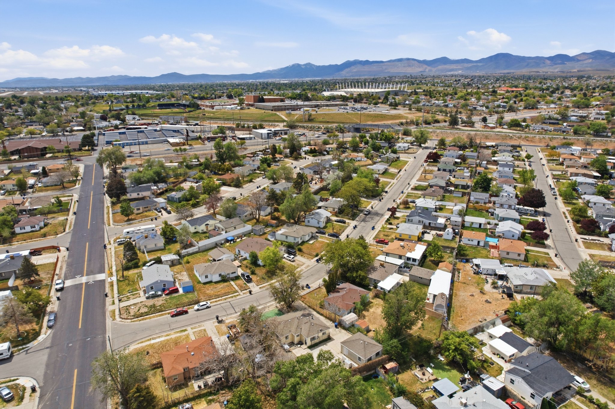 Aerial perspective showcasing a residential neighborhood with a distant mountain range backdrop