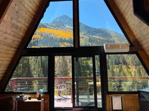Vaulted wood-paneled ceilings with expansive A-frame window frontage