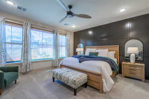 Recessed lighting illuminating a spacious room with light gray carpeting