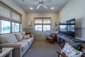 Spacious room featuring multiple windows with woven Roman shades, recessed lighting, and a ceiling fan