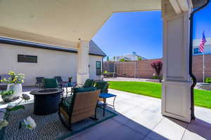 Covered patio with recessed lighting, an outdoor fire pit, and a concrete slab